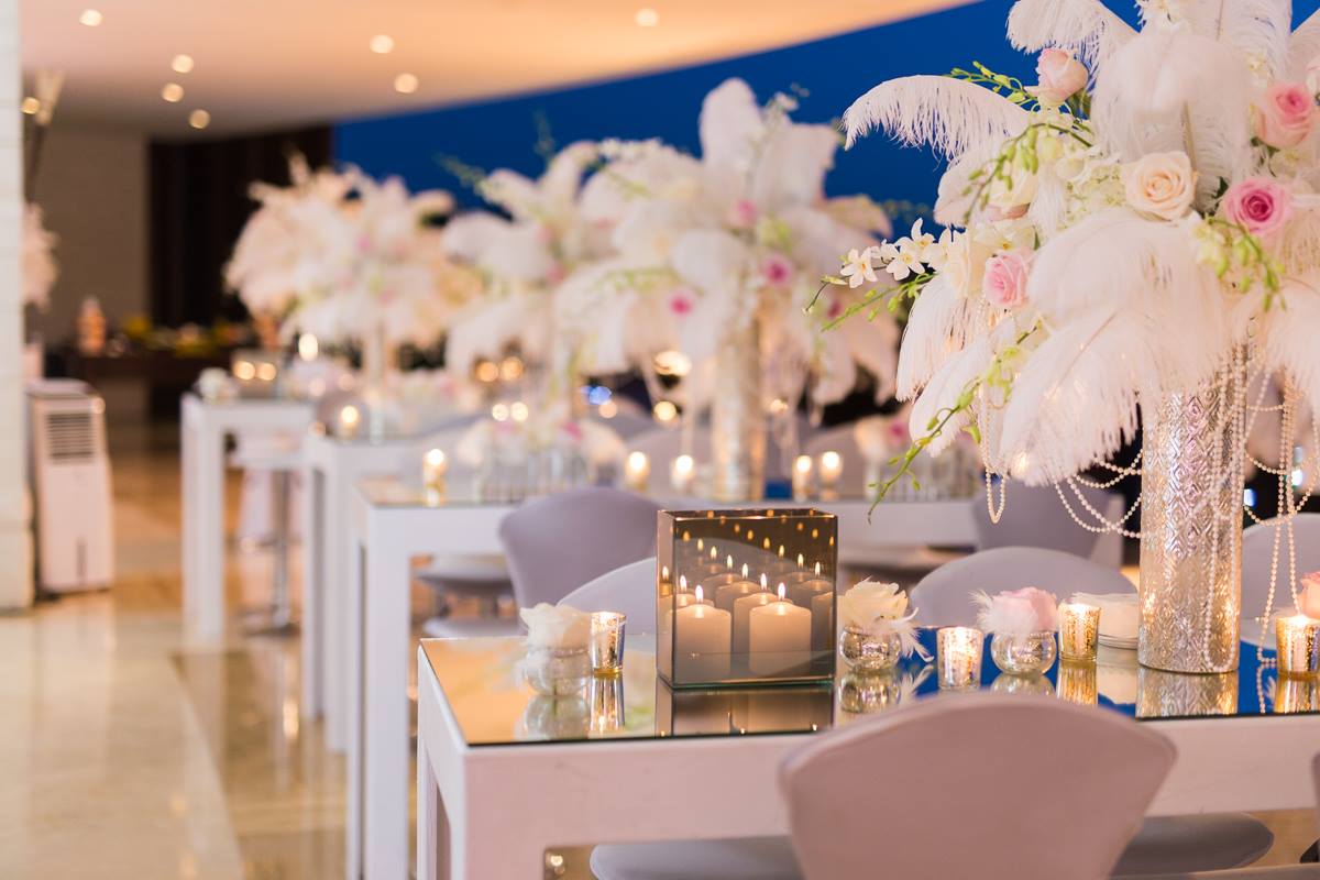 Elegant event floral décor with soft pink flowers, candles, and table arrangements created by Victoria Florist in Barbados.