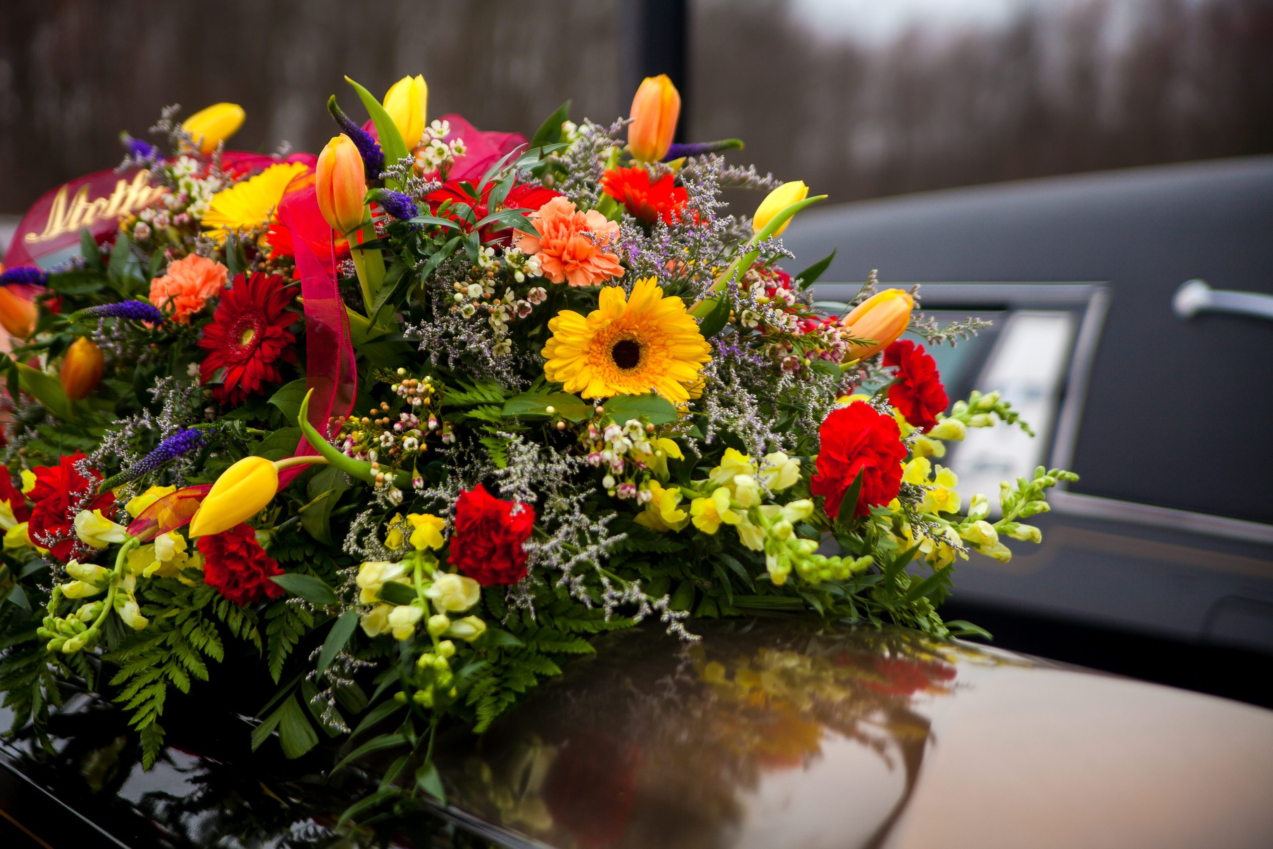 Colourful sympathy flower arrangement with lilies, gerberas, and carnations created by Victoria Florist in Barbados.