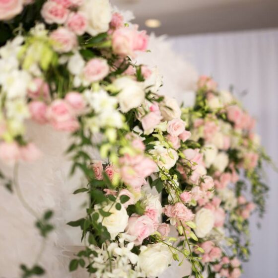 Pink and white wedding floral décor with roses and greenery created by Victoria Florist in Barbados.