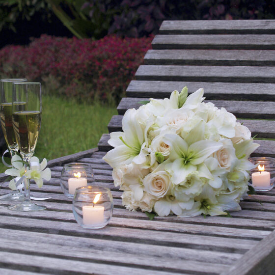 White bridal bouquet with roses and lilies designed by Victoria Florist for a Barbados wedding.